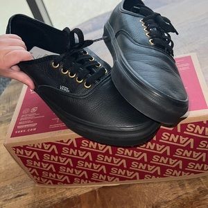 Black leather Vans with gold ‘trim’